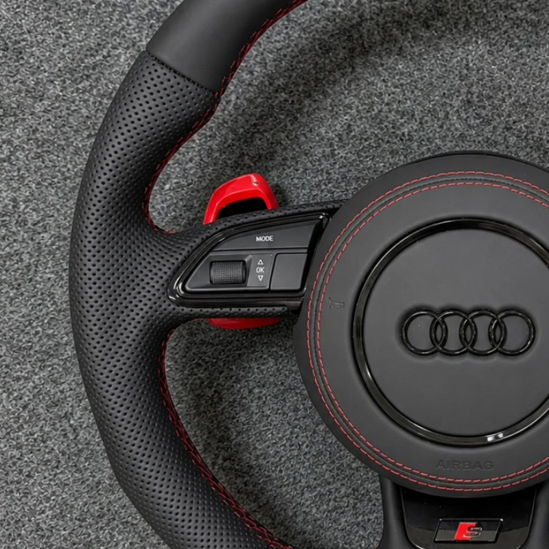 Semi perforated leather grip close up JIONX Audi sport steering wheel red stitching detail