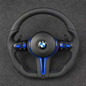 Custom BMW 7 Series leather steering wheel with blue trim, perforated grips, M-color stitching and paddle shifters
