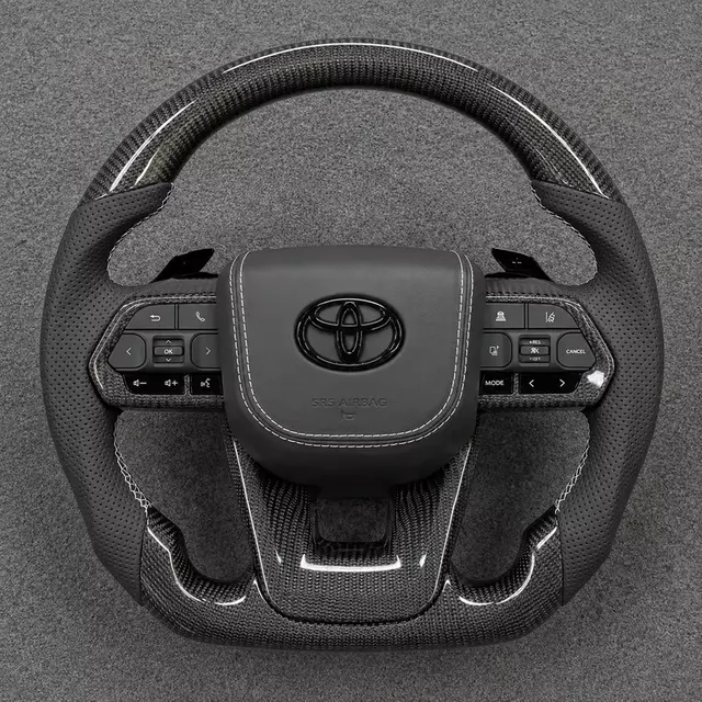 Toyota custom real carbon fiber steering wheel with perforated Nappa leather grips, paddle shifters and flat bottom