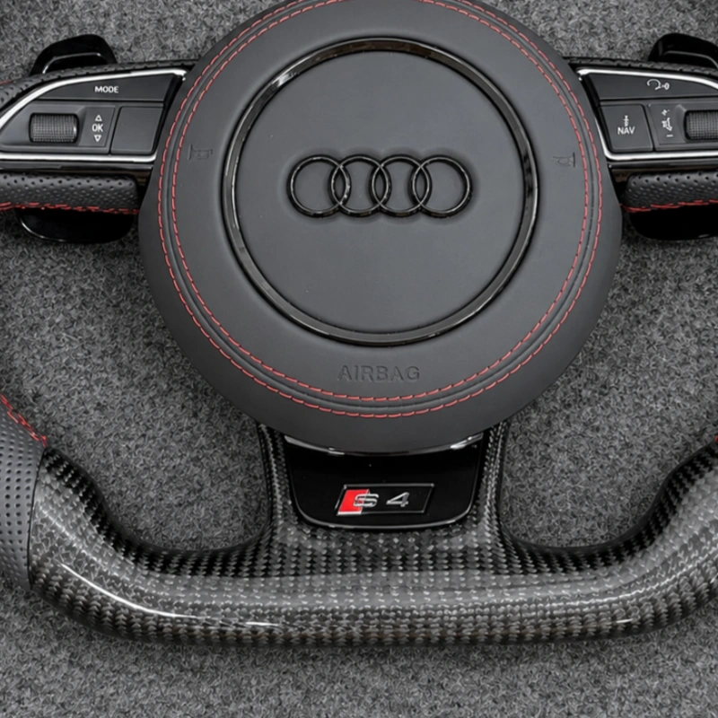 Close view S4 performance badge embedded on flat bottom forged carbon fiber spoke of Audi replacement steering wheel