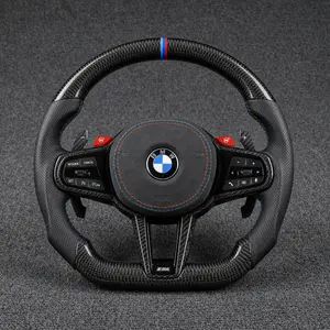 BMW M Performance carbon fiber steering wheel with perforated leather grips, M-color stripe and stitching, and red M buttons