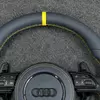 Closeup of yellow top center marker, perforated Nappa leather & yellow stitching on Audi B8 steering wheel