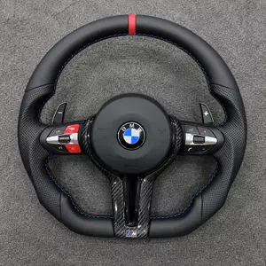 Custom BMW M Sport flat-bottom steering wheel with red center stripe, blue stitching, red buttons and carbon fiber trim
