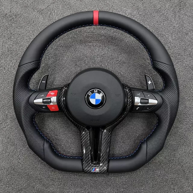 Custom BMW M Sport flat-bottom steering wheel with red center stripe, blue stitching, red buttons and carbon fiber trim