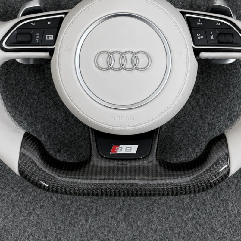 Close up flat bottom gloss carbon fiber trim with S logo two tone white leather steering wheel for Audi A Q S RS series