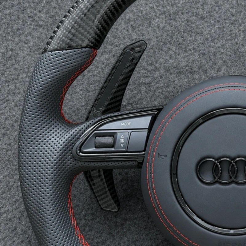 JIONX breathable perforated leather with red stitching on Audi carbon steering wheel