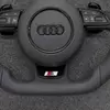 JIONX Exclusive S Series Sport Metal Badge Closeup On Audi Flat Bottom Steering Wheel