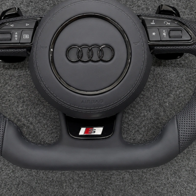 JIONX Exclusive S Series Sport Metal Badge Closeup On Audi Flat Bottom Steering Wheel