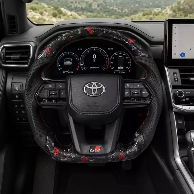 Toyota custom red fleck forged carbon fiber steering wheel installed in a compatible Toyota interior