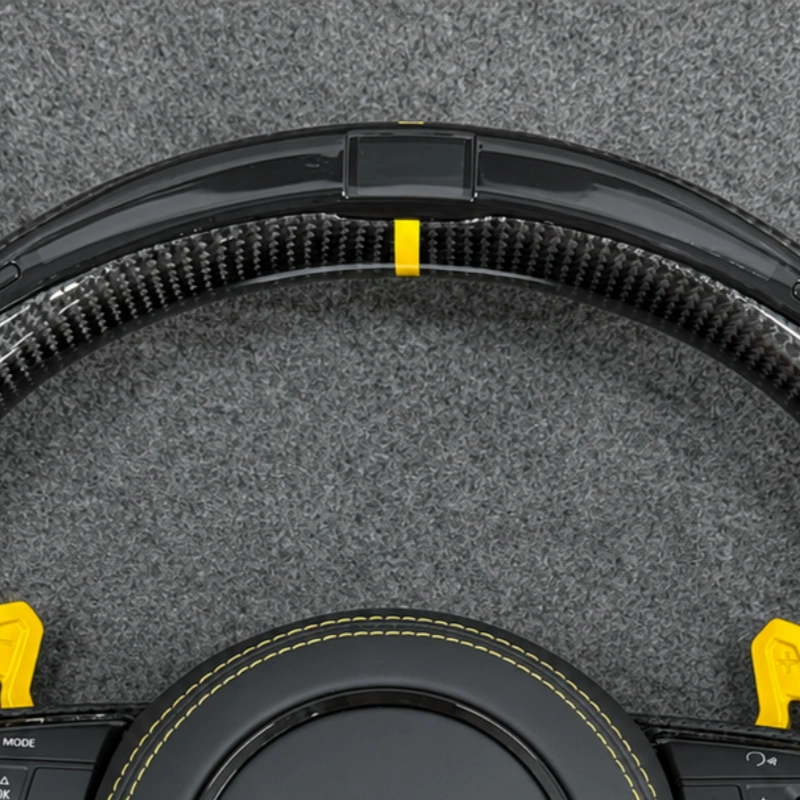 Clos up yellow racing marker and LED carbon fiber top trim for Audi RS custom flat bottom steering wheel