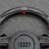 Close up view of top red racing marker stripe on high-gloss forged carbon fiber steering wheel rim for Audi S4