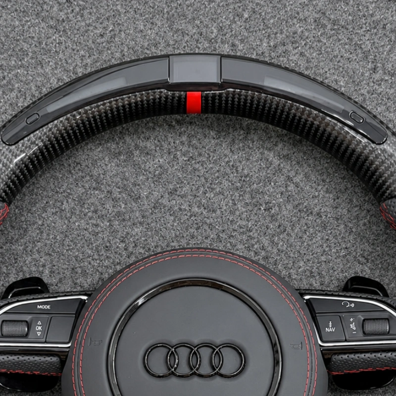 Close up view of top red racing marker stripe on high-gloss forged carbon fiber steering wheel rim for Audi S4