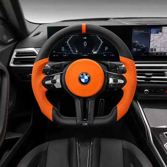 BMW 2 Series cockpit with a custom orange Nappa leather steering wheel, real carbon fiber trim and flat-bottom design