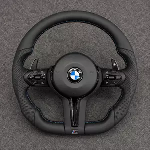 BMW M4 F82 cockpit with a custom black Nappa leather steering wheel, perforated grips, M-color stitching and paddle shifters