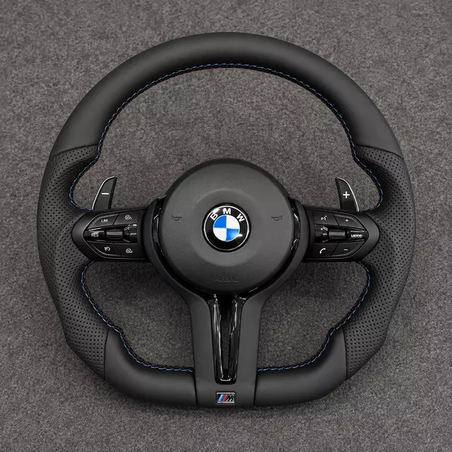 BMW M4 F82 cockpit with a custom black Nappa leather steering wheel, perforated grips, M-color stitching and paddle shifters