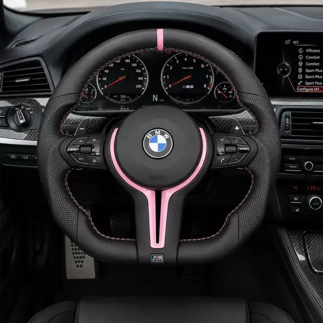 BMW M5 custom pink-accent leather steering wheel installed with paddle shifters and multifunction controls