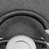 Close up glossy carbon fiber rim of two tone flat bottom white leather steering wheel for Audi A3 Q5 RS7