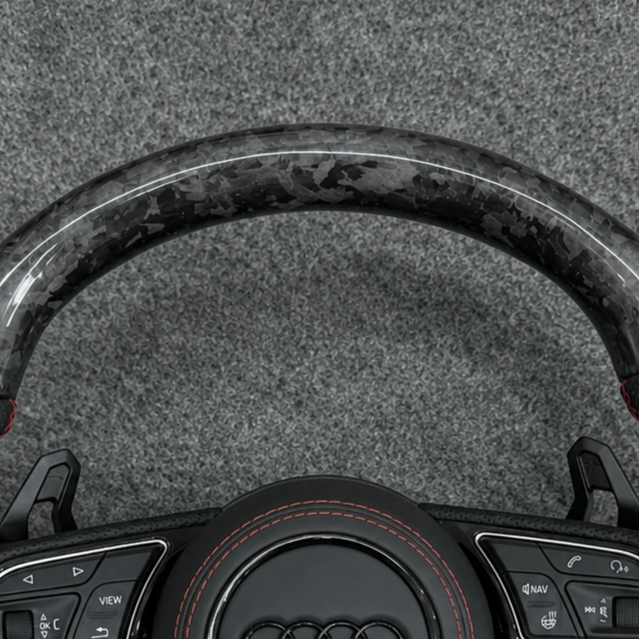 Genuine forged carbon fiber texture closeup on Audi sport steering wheel