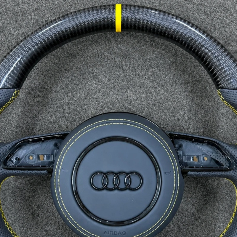 Close up of JIONX carbon wheel yellow top center marker stripe, glossy forged carbon fiber texture