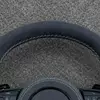 JIONX S sport metal badge closeup on custom suede Audi steering wheel