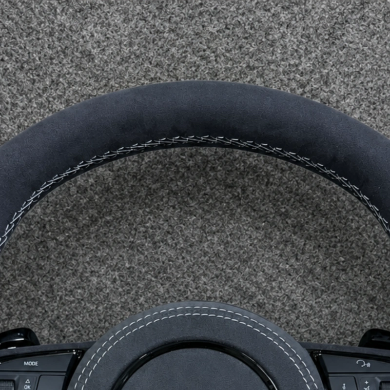 JIONX S sport metal badge closeup on custom suede Audi steering wheel