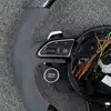 Closeup Of Left Multi-Function Control Buttons On Audi Carbon Alcantara Steering Wheel JIONX
