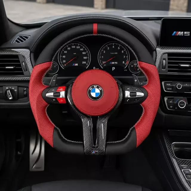 Custom BMW M5 red perforated leather and carbon fiber steering wheel installed with paddle shifters