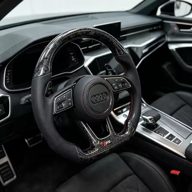 Forged carbon fiber steering wheel installed in Audi B9 interior with shift paddles sport cabin upgrade