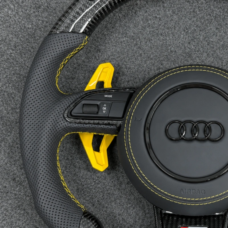 Semi perforated leather grips with yellow stitching on Audi LED carbon flat bottom replacement wheel