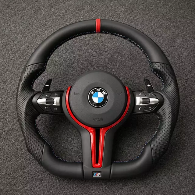 Custom BMW 7 Series leather steering wheel with red trim, perforated grips, paddle shifters and M-color stitching