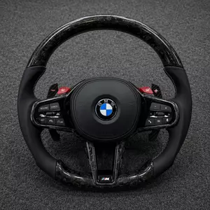 BMW M Performance forged carbon fiber steering wheel with black leather grips, red M buttons, paddle shifters and flat bottom