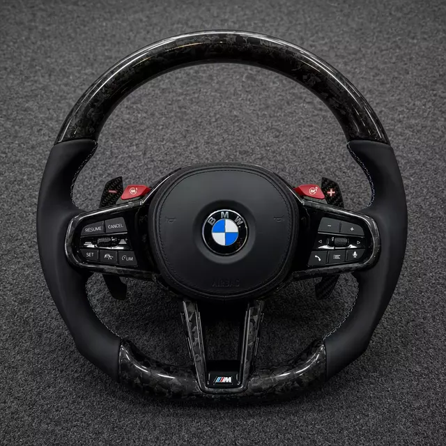 BMW M Performance forged carbon fiber steering wheel with black leather grips, red M buttons, paddle shifters and flat bottom