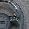 Close up glossy forged carbon fiber upper and bottom rim for Audi RS flat bottom sport steering wheel