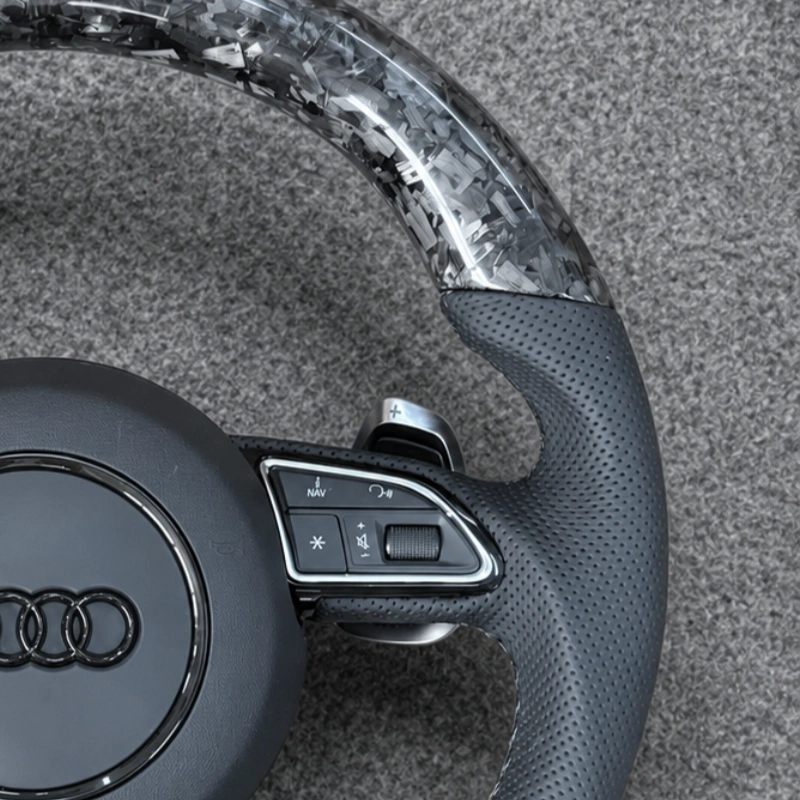 Close up glossy forged carbon fiber upper and bottom rim for Audi RS flat bottom sport steering wheel