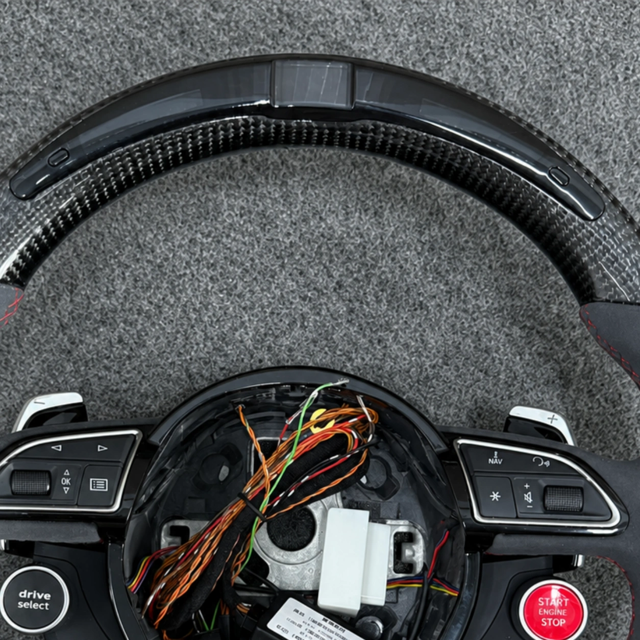 Closeup Of Top LED Light Strip On Gloss Carbon Fiber Rim Of Audi Steering Wheel JIONX