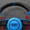 Close-up of glossy woven carbon fiber spokes on JIONX steering wheel for Audi A7 S7 RS7 C7
