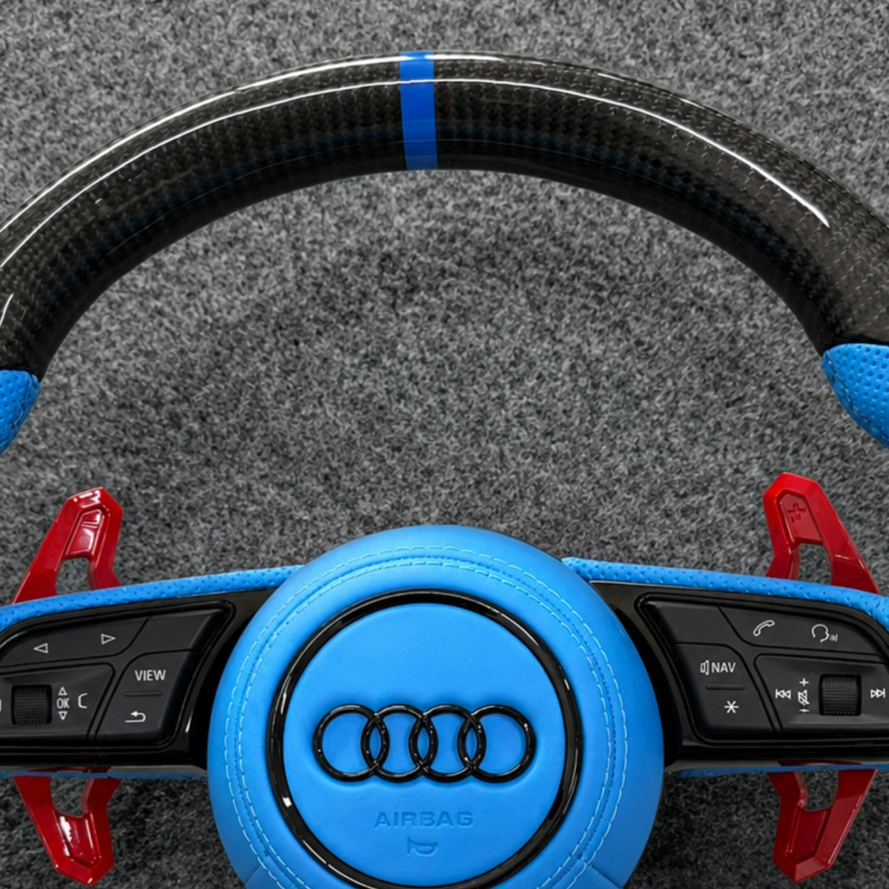 Close-up of glossy woven carbon fiber spokes on JIONX steering wheel for Audi A7 S7 RS7 C7
